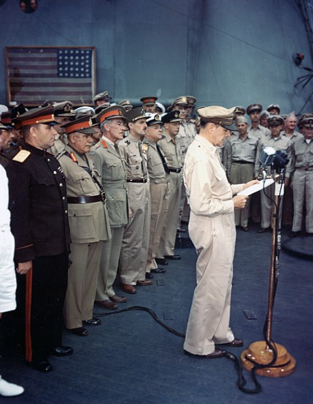 General Douglas MacArthur presides over the signing of the formal Japanese surrender documents aboard the USS Missouri in Tokyo Bay on September 2, 1945.